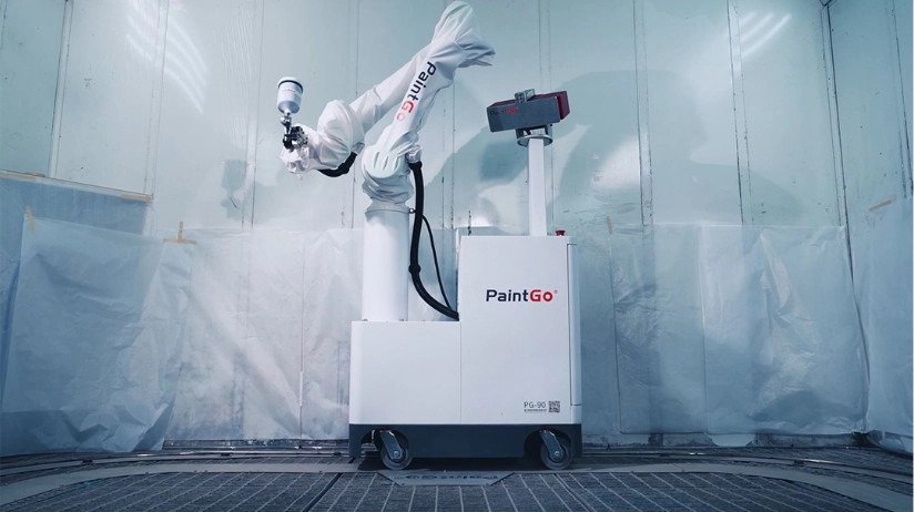 Robotic paint sprayer stationed inside spray booth
