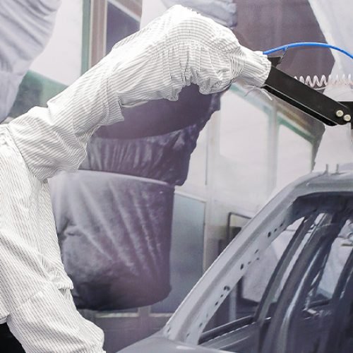 Robotic arm painting a car in spray booth